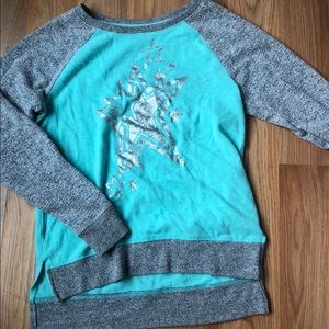 A turquoise girls sweater